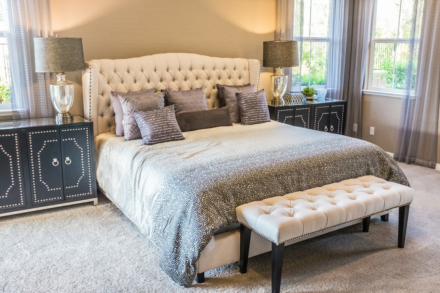 A guest room with a made bed and soft lighting