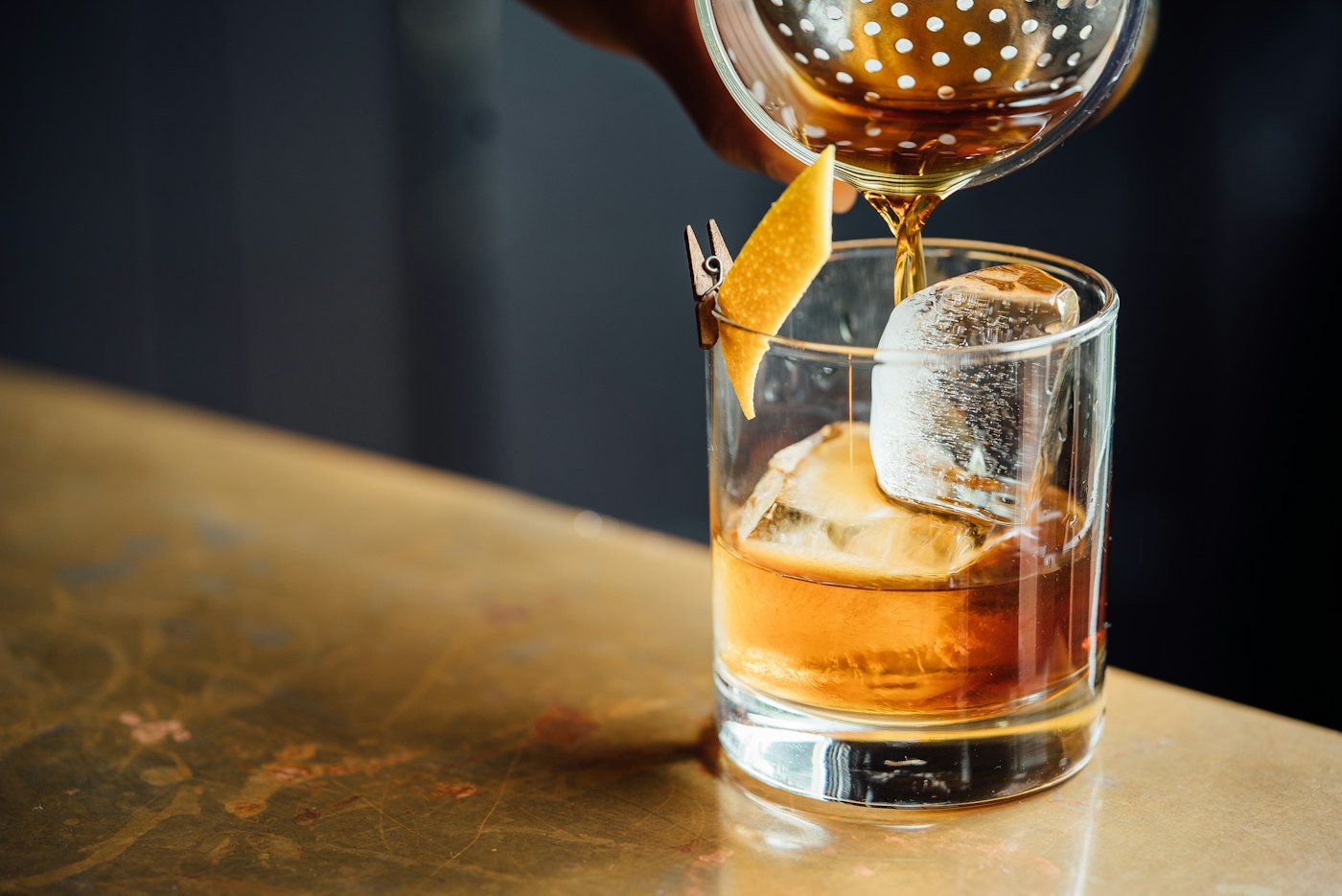 A whisky being poured over ice